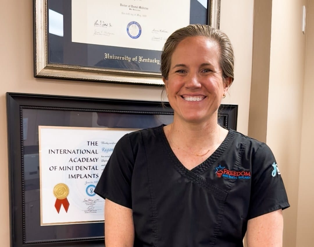 Dentist using a conventional implant model to discuss options with older patients