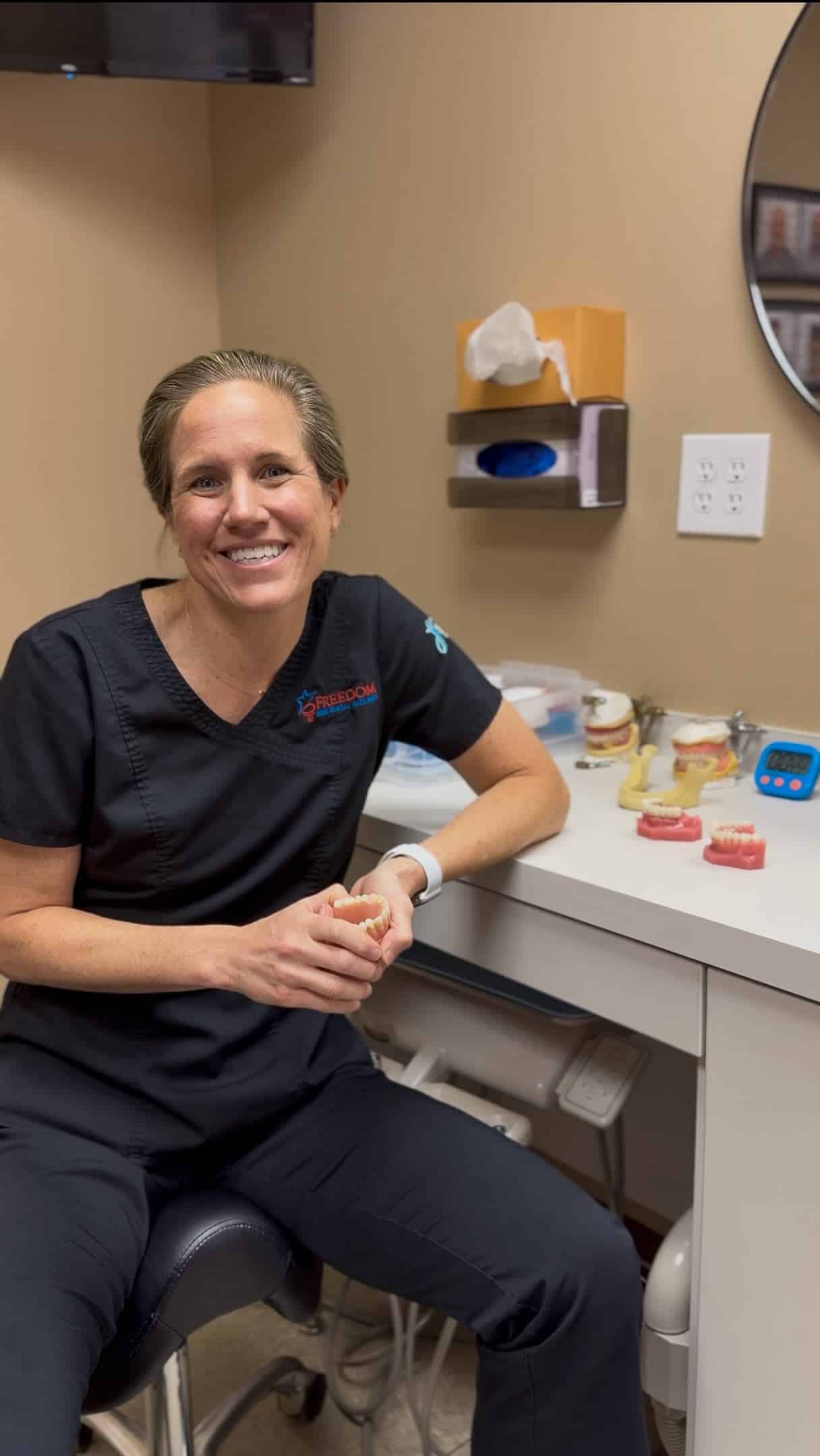 Dentist discussing a denture model with a patient