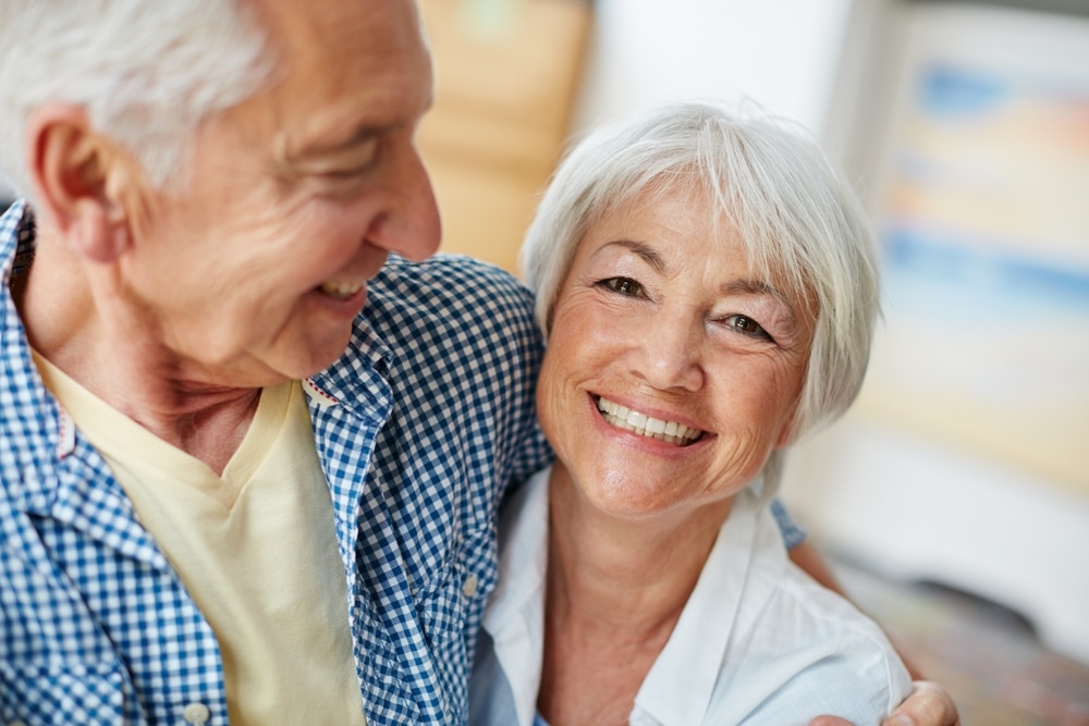 Older couple smiling together at home