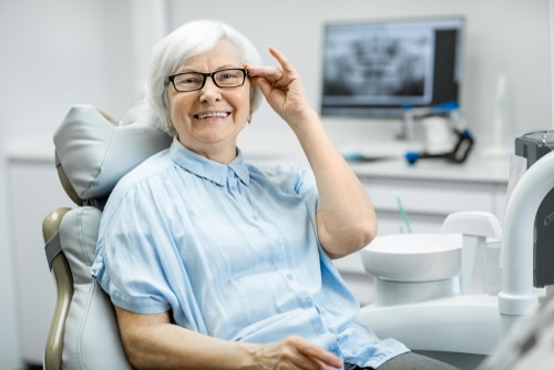 Patient smile after secure snap-in dentures in Louisville
