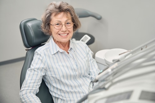 Patient smile after dental implants in Louisville