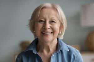 Patient smile with removable snap-in dentures in Louisville