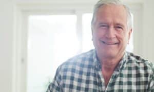 Patient smile with mini implant-supported dentures in Louisville