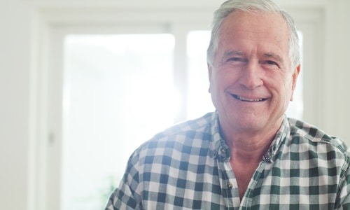 Patient smile with mini implant-supported dentures in Louisville