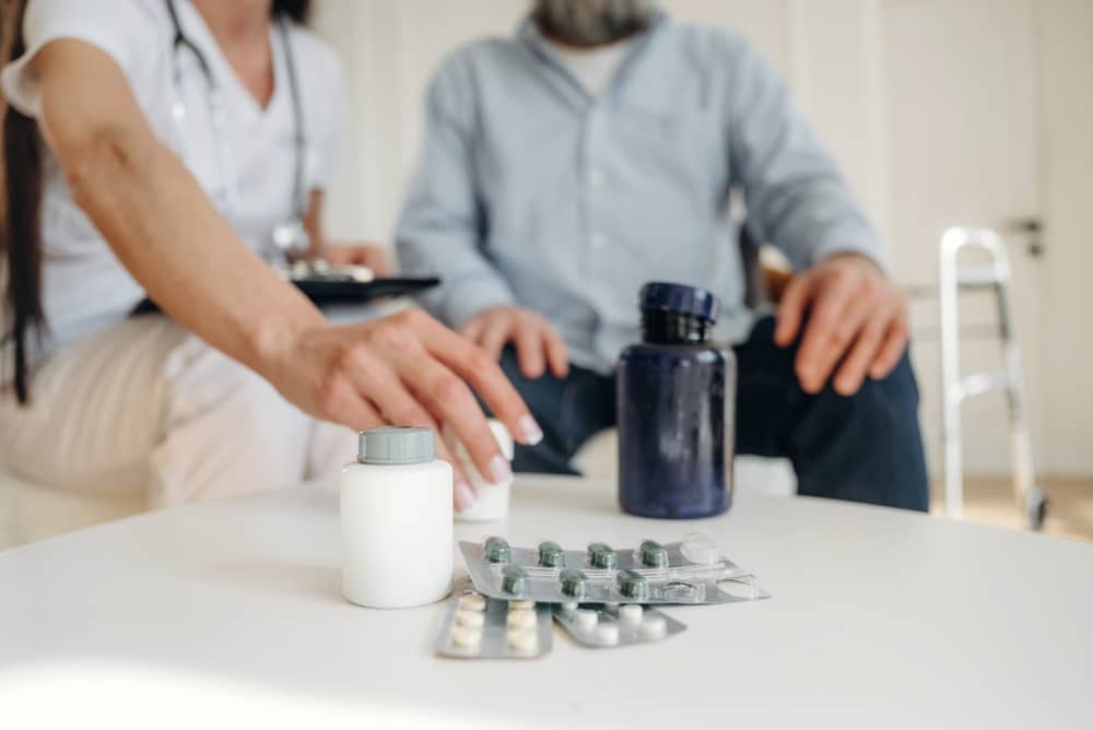 Medical professional reviewing medication options with an older patient