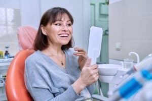 Patient smile after mini dental implants in Louisville