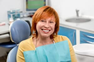 Patient smile after mini dental implants in Louisville